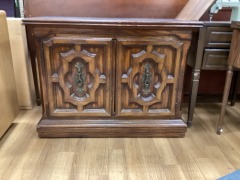 BROWN BUFFET WITH ORNATE DOORS AND BLACK TOP