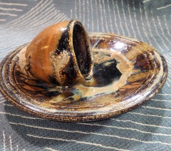 Glazed brown pottery plate and cup