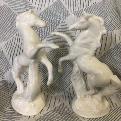 A vintage set of porcelain figurines featuring rearing horses, possibly from the mid-20th century.