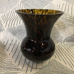 Hand-blown art glass vase featuring an amber body with a black or dark brown \