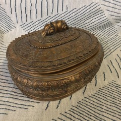 vintage-style ornate metal jewelry or trinket box