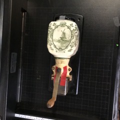 vintage Dutch Delft-style ceramic wall-mounted coffee grinder.