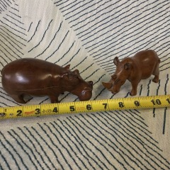 vintage, hand-carved wooden animal figurines, a hippopotamus, and a rhinoceros.