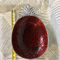 pineapple-shaped metal serving bowl featuring a vibrant red enamel interior