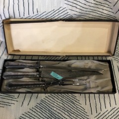 vintage Wallace silverplate carving set featuring a knife, fork, and sharpener