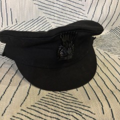 Classic black chauffeur cap featuring a traditional cockade detail.