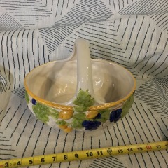 vintage glazed ceramic basket featuring a prominent handle, hand-painted grapes, and lemons