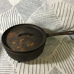 vintage cast iron footed skillet or deep chicken fryer with a lid
