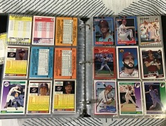 Binder with various baseball cards from the 1980s, primarily featuring cards from Fleer, Donruss, and Score.