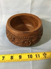 Vintage, handcrafted teak wood bowl featuring intricate floral carvings around the exterior.
