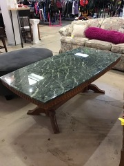 vintage coffee table features a green marble top set on a carved wooden base